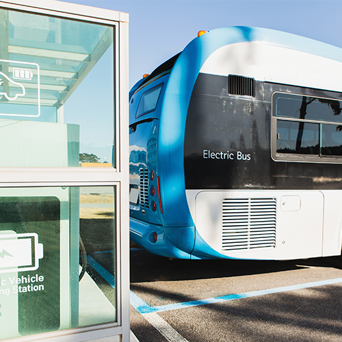 Electric bus using an Ingersoll Rand air compressor parked on an electric vehicle charging station